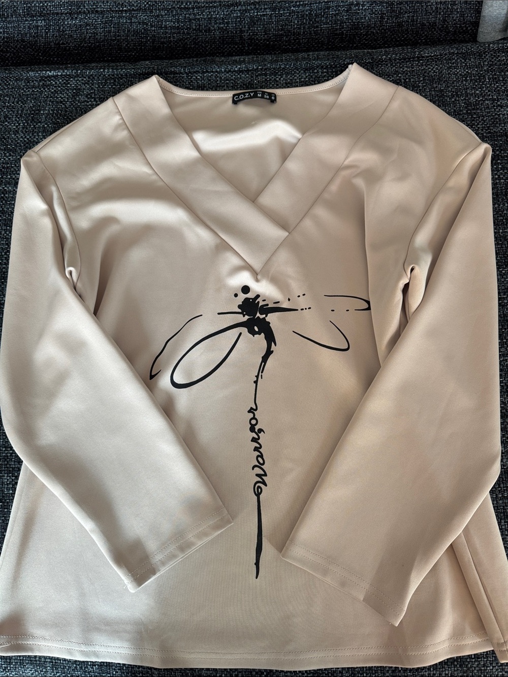 Cozy Beige V-Neck Top with Dragonfly Graphic “Warrior”.